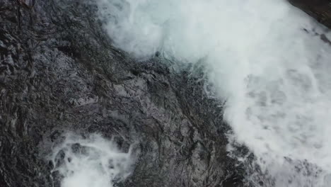 Close-up-top-down-view-of-water-from-Panther-Creek-Falls-flowing-into-Panther-Creek,-Washington-State