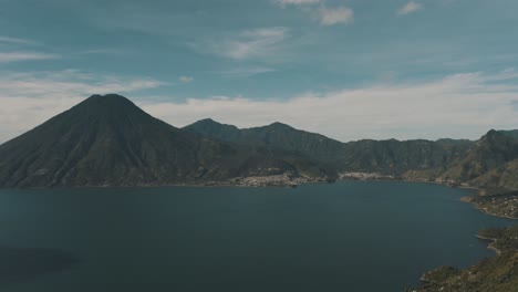 drone aerial overview of lake atitlan and the beautiful volcanoes around it in guatemala