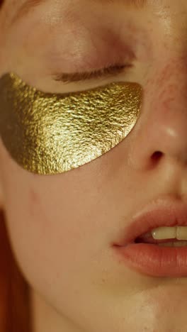 woman with gold eye patches