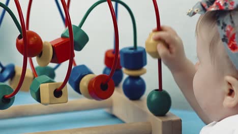 child plays with a multi-colored toy 23