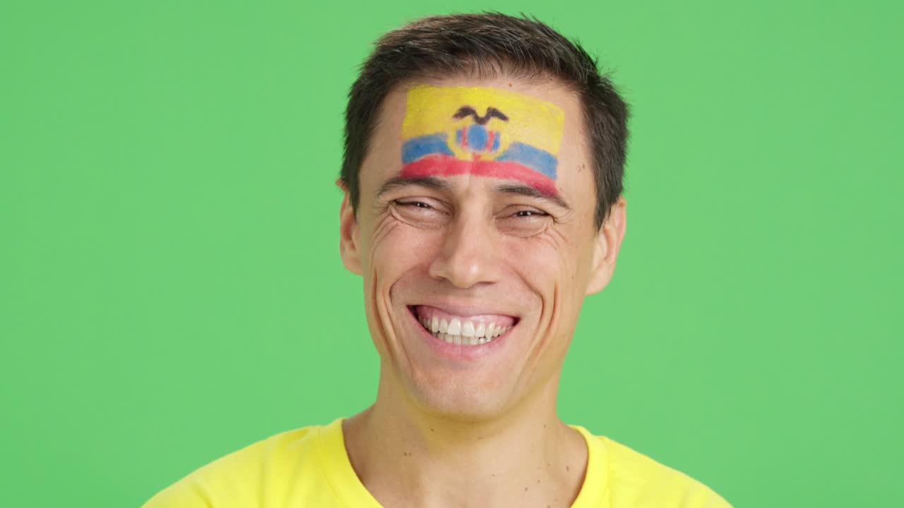 Man with a ecuadorian flag painted on the face smiling