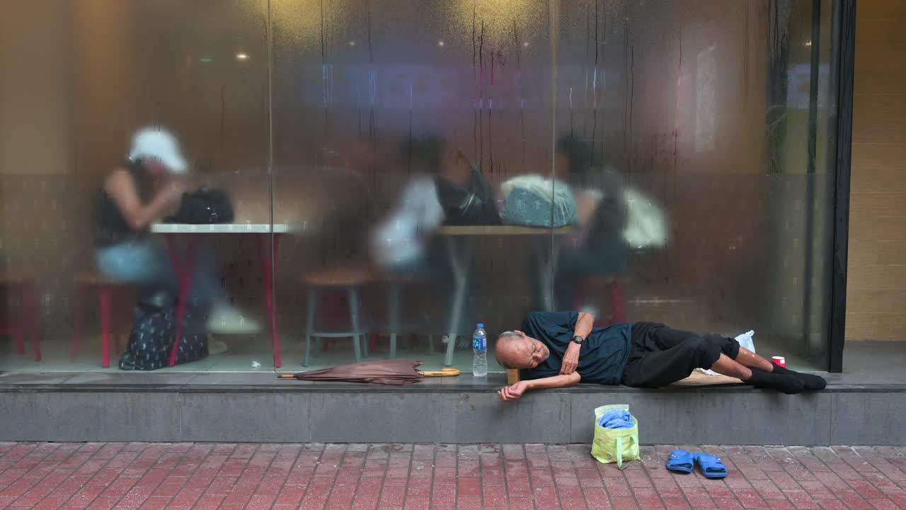 Homeless man sleeping on the street in Hong Kong