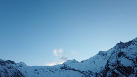 moving timelapse: swiss alps mountains in saas fee after the sunset, with a few moving clouds
