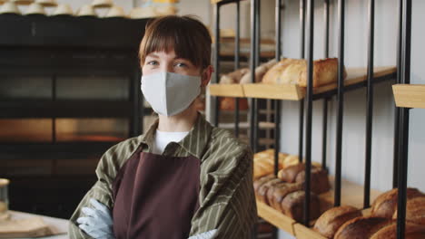 Portrait-of-Female-Worker-in-Mask-and-Gloves-in-Bakery