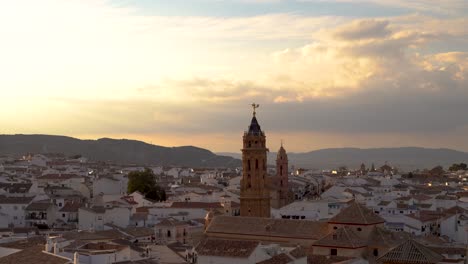 panoramic view high above typical spanish city with church at sunset