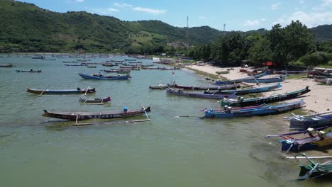 hundreds of boats along the coastline of lombok, indonesia on a hot summers day, aerial