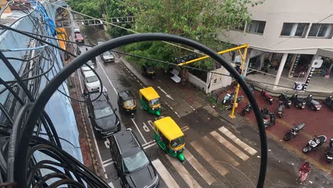 wide view, men are obeying traffic signals under the bridge even in the pouring rain