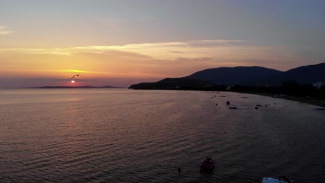 Aerial-sideward-and-backward-flight-of-captivating-dark-coastal-view-at-sunset,-Turkey