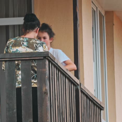 girls using phone on balcony