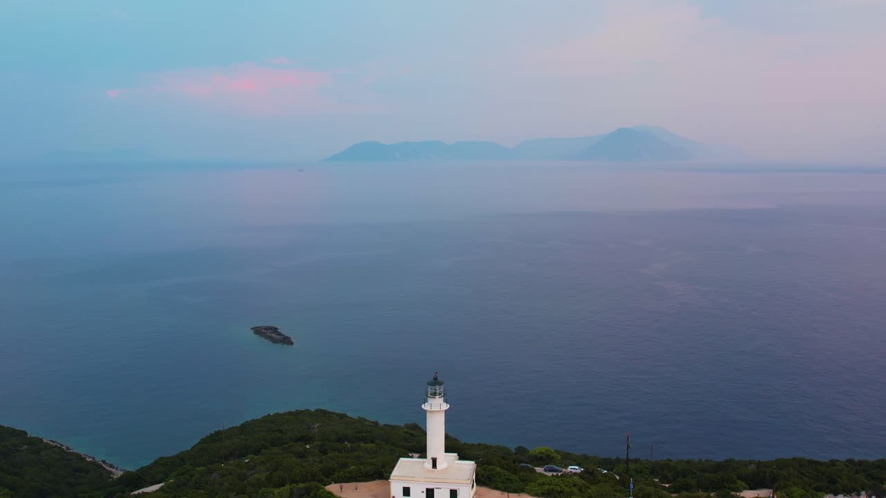 Aerial View Of Misty Ionian Sea With Pullback Shot To Reveal Douk&aacute;to Lighthouse On Lefkada On Cliff Edge