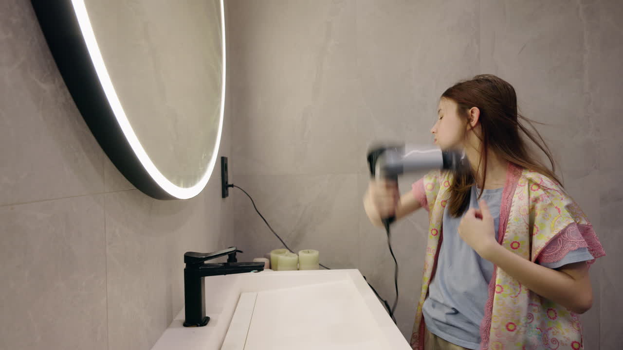 Teenage Girl Drying Hair and Getting Ready in a Bathroom