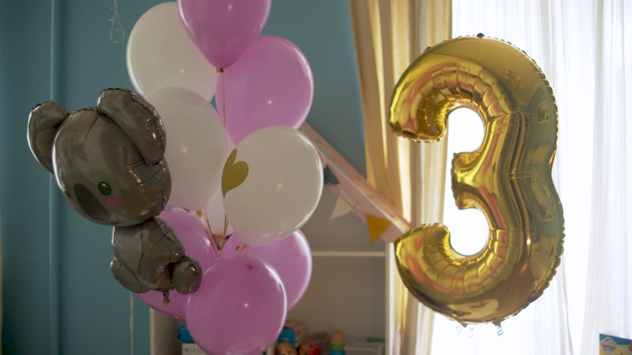 Birthday balloons in bright room