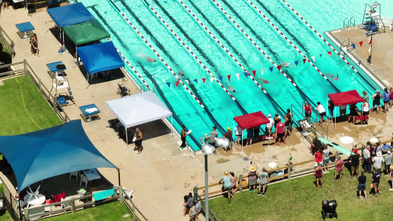 Bird's-eye view of sporting event with people gathered from around the town