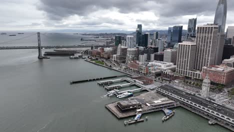 aerial footage of downtown san francisco along with the bay bridge, and ferry building