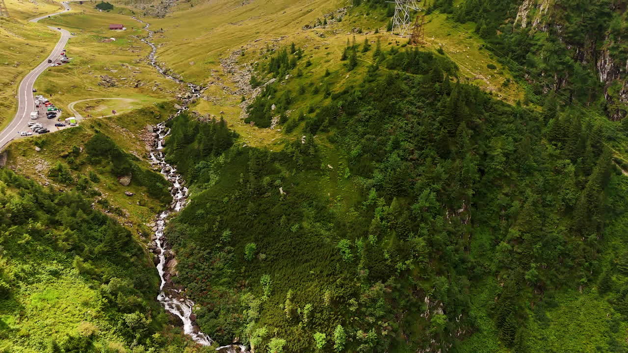 Beautiful greenery covering the huge mountains. Drone flight over the Transfagarash highway in the Carpathian Mountains, Romania