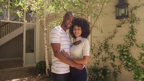 happy mixed race couple enjoying in the garden during a sunny day