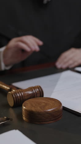 judge striking gavel in courtroom