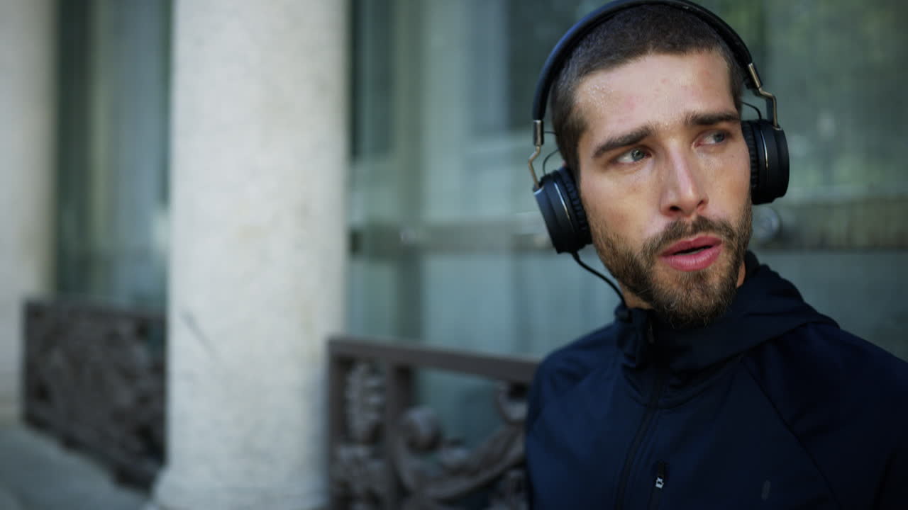 Man taking a break from running outdoors