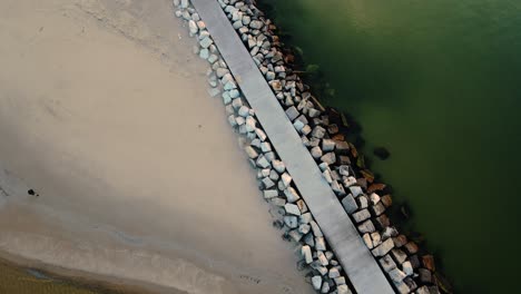 stone boardwalk leading to the lighthouse at pere marquette beach