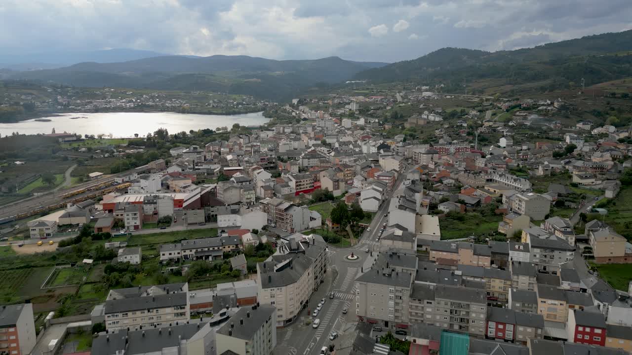 Sweeping aerial of A Rúa, Galicia, with town features blending into hilly natural surroundings