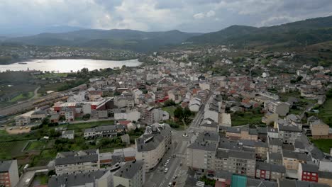 sweeping aerial of a rúa, galicia, with town features blending into hilly natural surroundings
