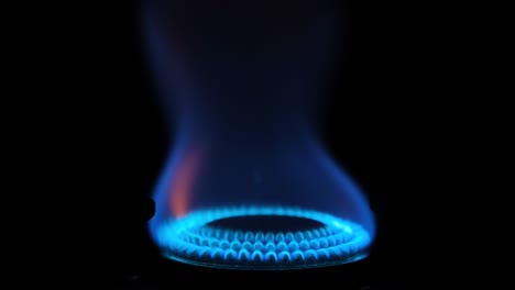 gas stove being turned on isolated on black background. natural gas deficit concept. 4k resolution video