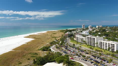 Aerial-view-of-parking-place-and-beachfront-apartments-in-Siesta-Key,-white-sand-beach-in-Sarasota,-Florida