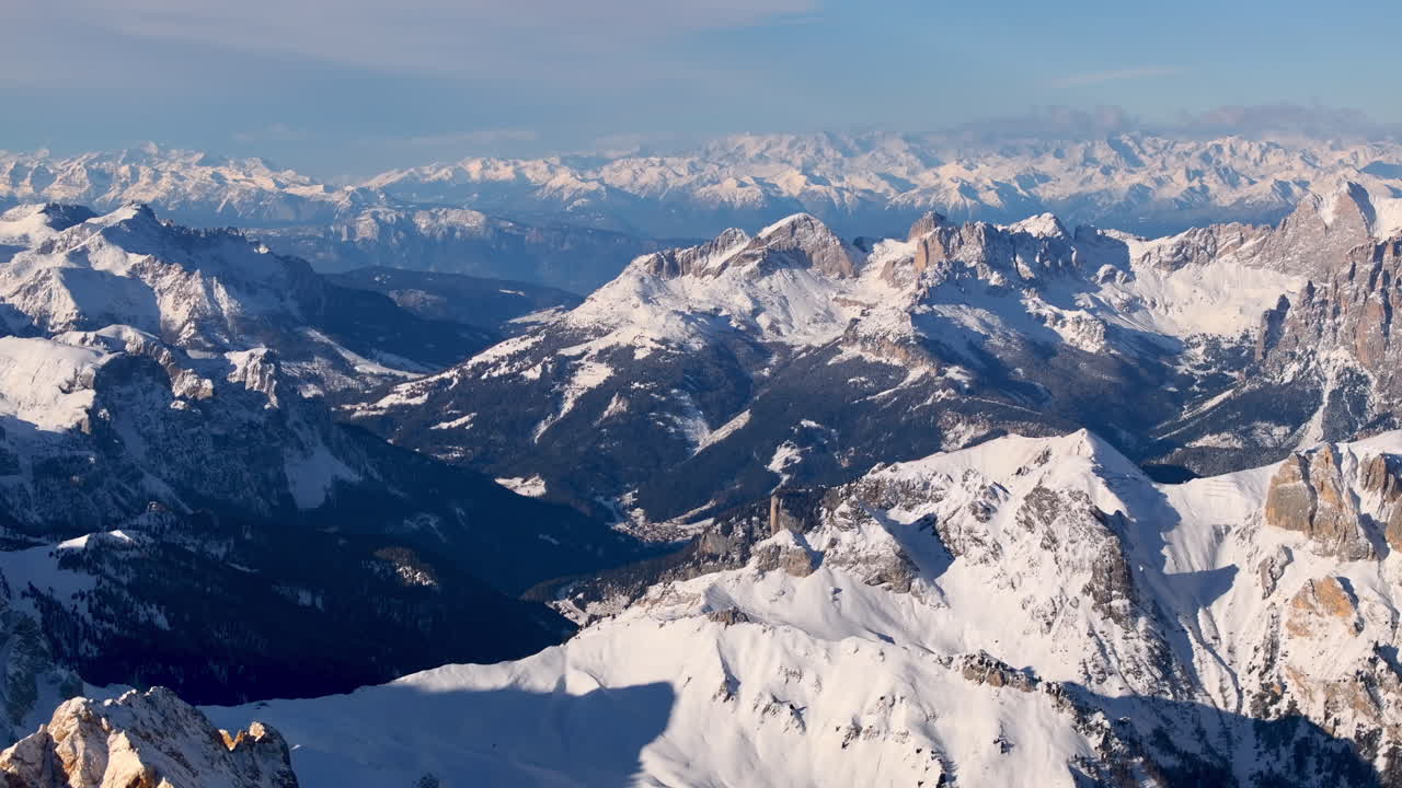 Aerial drone view of the Marmolada mountain in the Dolomites, northeastern Italy with the blue sky on the background