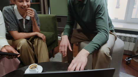 adults having a relaxed conversation and smiling in an indoor setting
