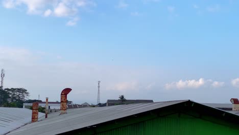 industrial chimneys on the roof of factory building which produces smoke from combustion activity