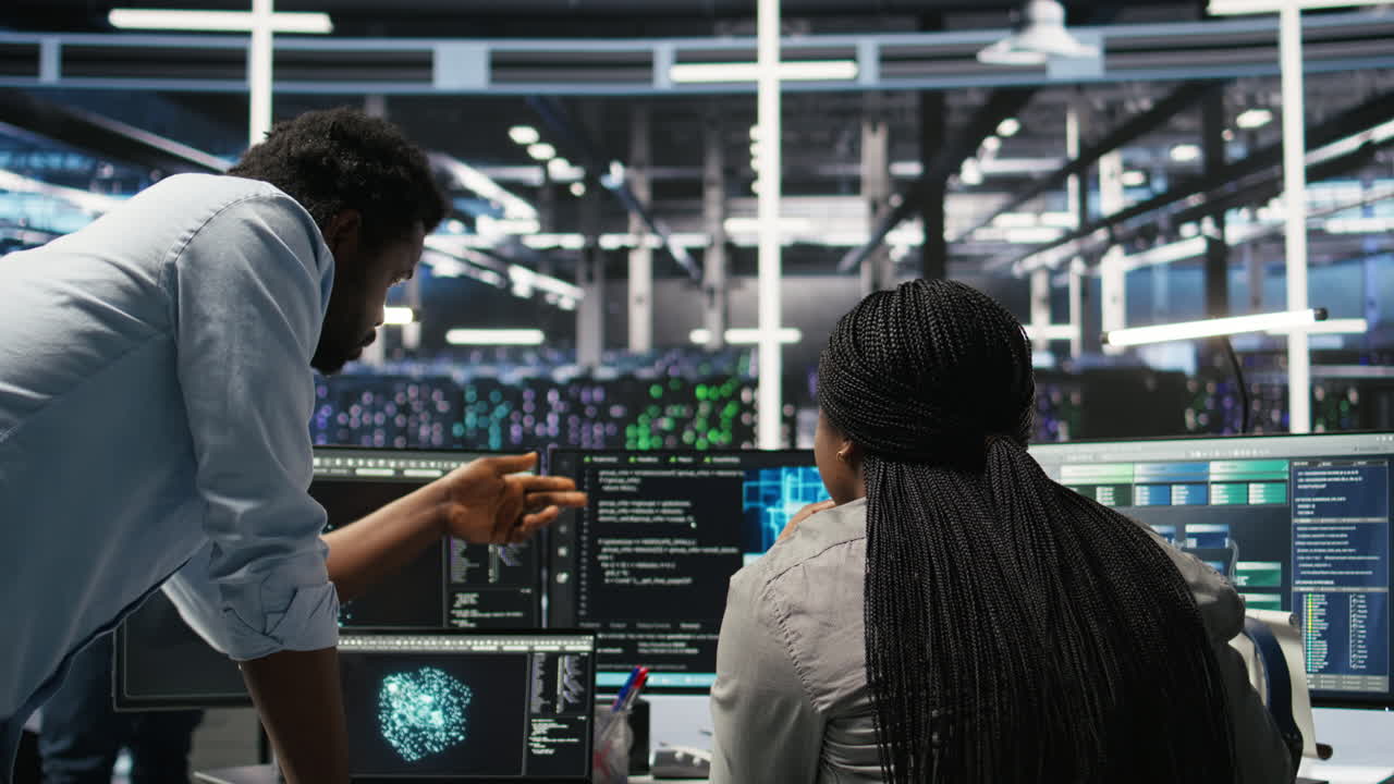 Data center manager supervising worker deploying AI solutions