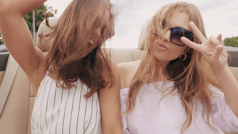 two happy women having fun in a convertible car