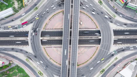 time-lapse of car traffic transportation above roundabout road. drone aerial top view. public transport or commuter city life concept