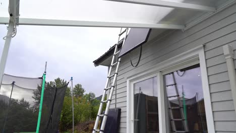 solar panel lowered down from roof of private home - removal of failed solar panel installation with low yield - static