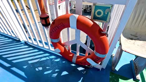 ferry approaches dock with visible safety equipment