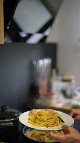 preparing fettuccine pasta dish