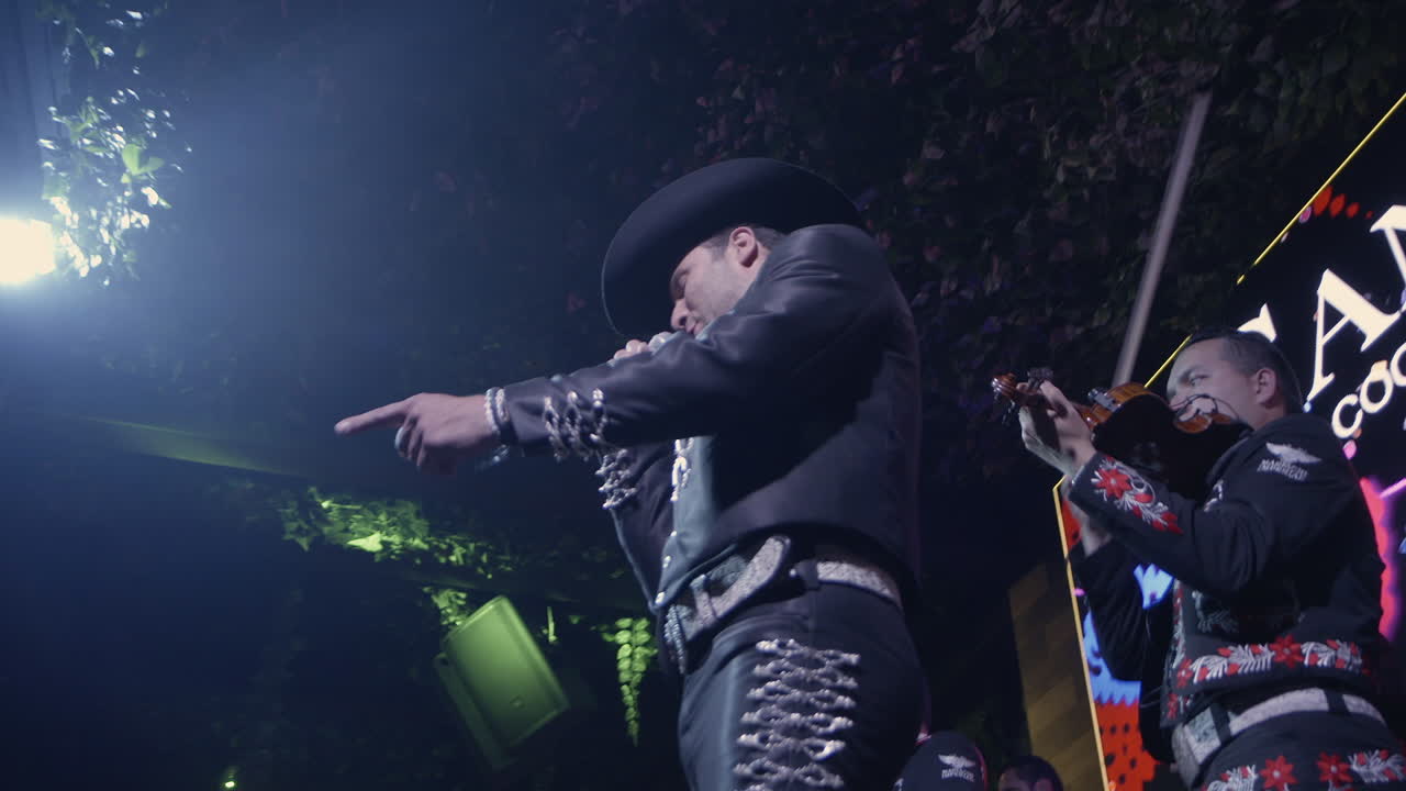 skilled Mariachi singer captivates the crowd with their passionate performance in a lively club