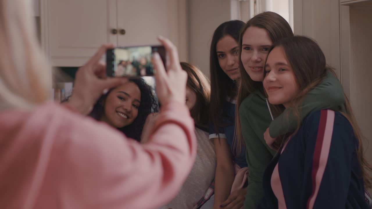 Diverse teenage girls posing for photo at home having fun together ...
