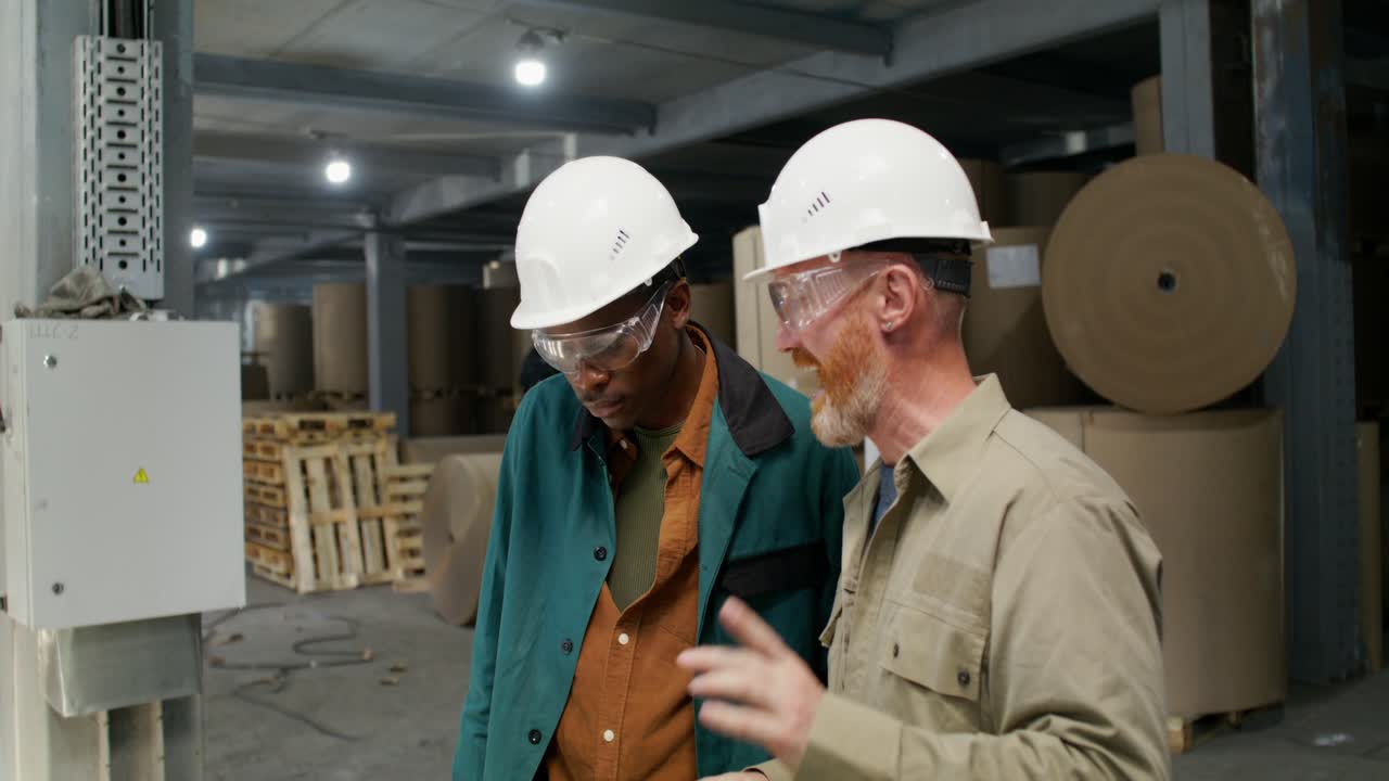 Factory Workers Discussing in a Warehouse