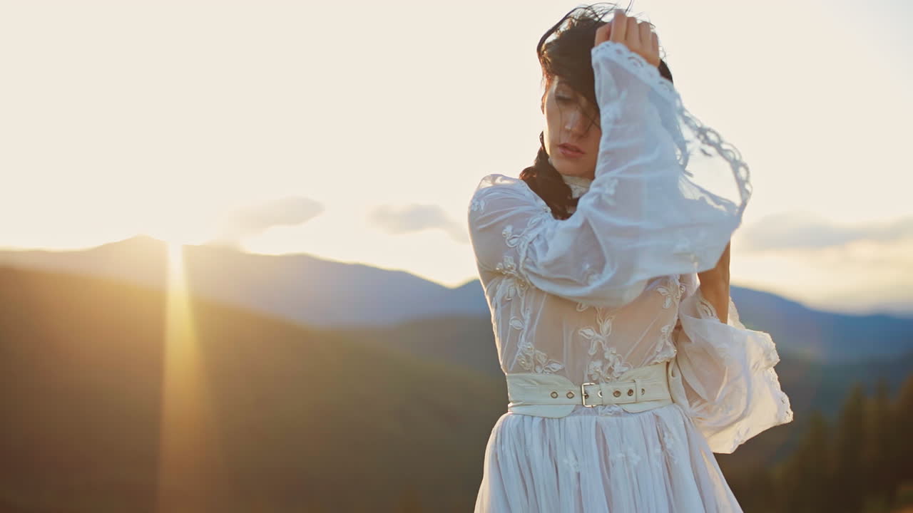 Woman in White Dress at Sunset in the Mountains