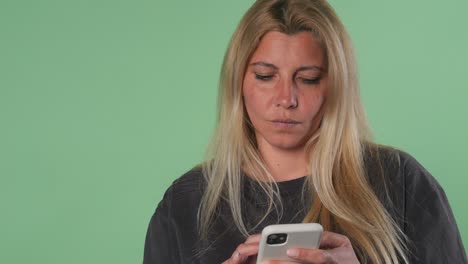 woman texting on smart phone with frustrated expression green screen chroma key