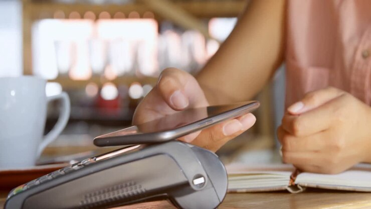 Teenage girl making payment through NFC 4k