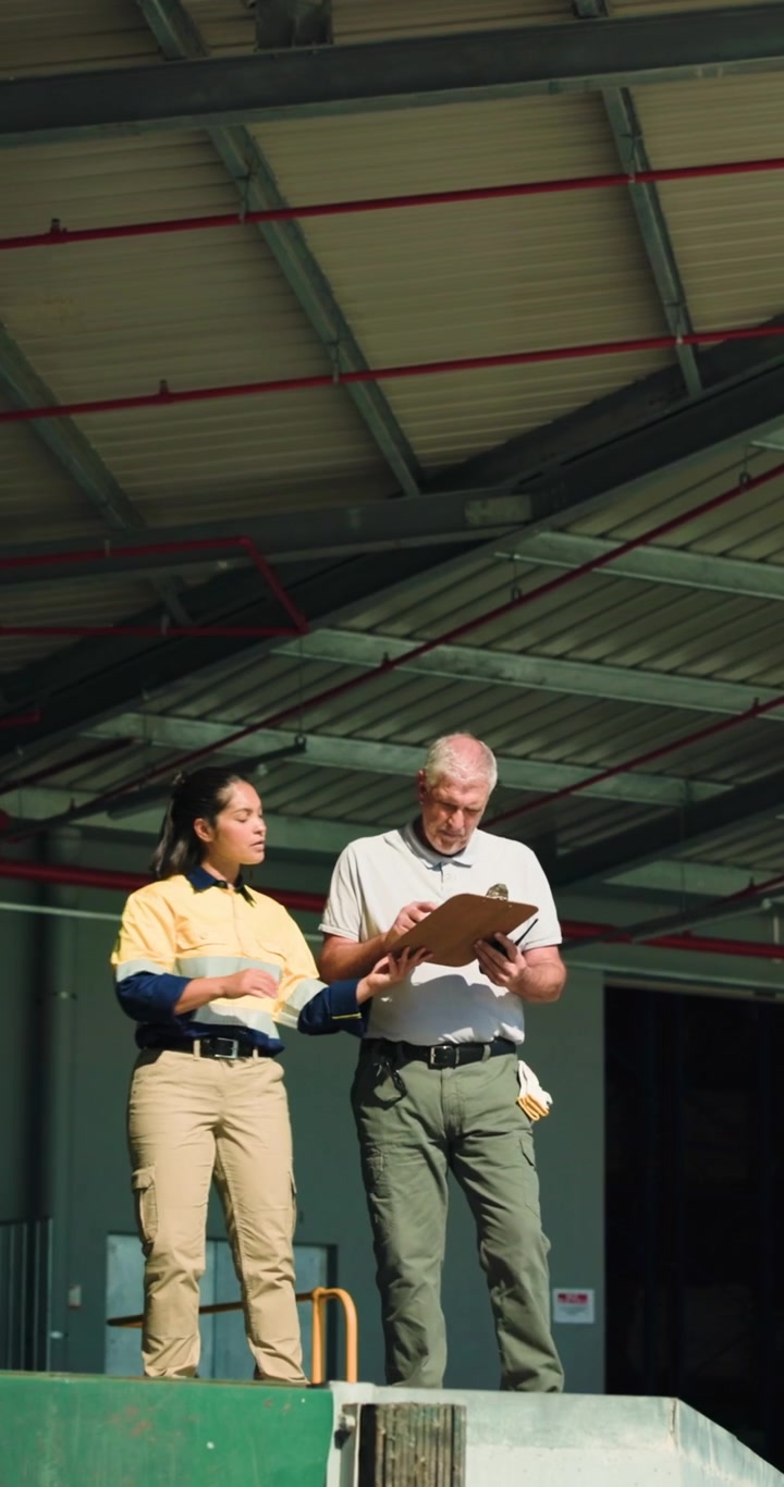 Warehouse Workers Reviewing Inventory on Clipboard
