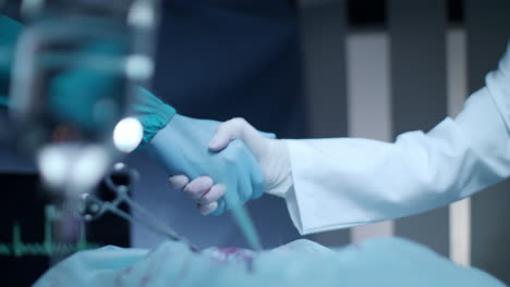 Surgeon-doctor-handshake.-Surgeon-team-congratulation-successful-operation