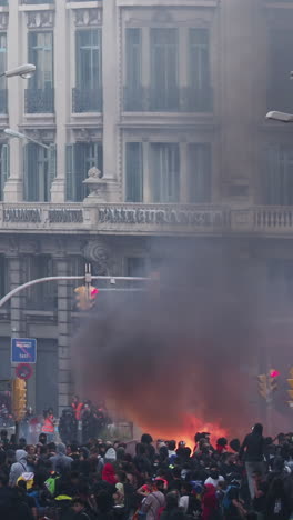 barcelona - spain - october 18 2019 : riot police clash with protestors at the general strike in via laietana, barcelona in vertical