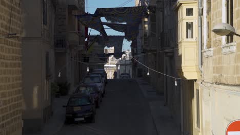 old and narrow streets of malta with flags during its festive days