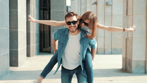 couple having fun piggyback ride in the city