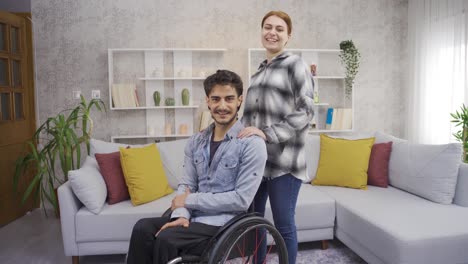 woman and disabled man having happy time at home.