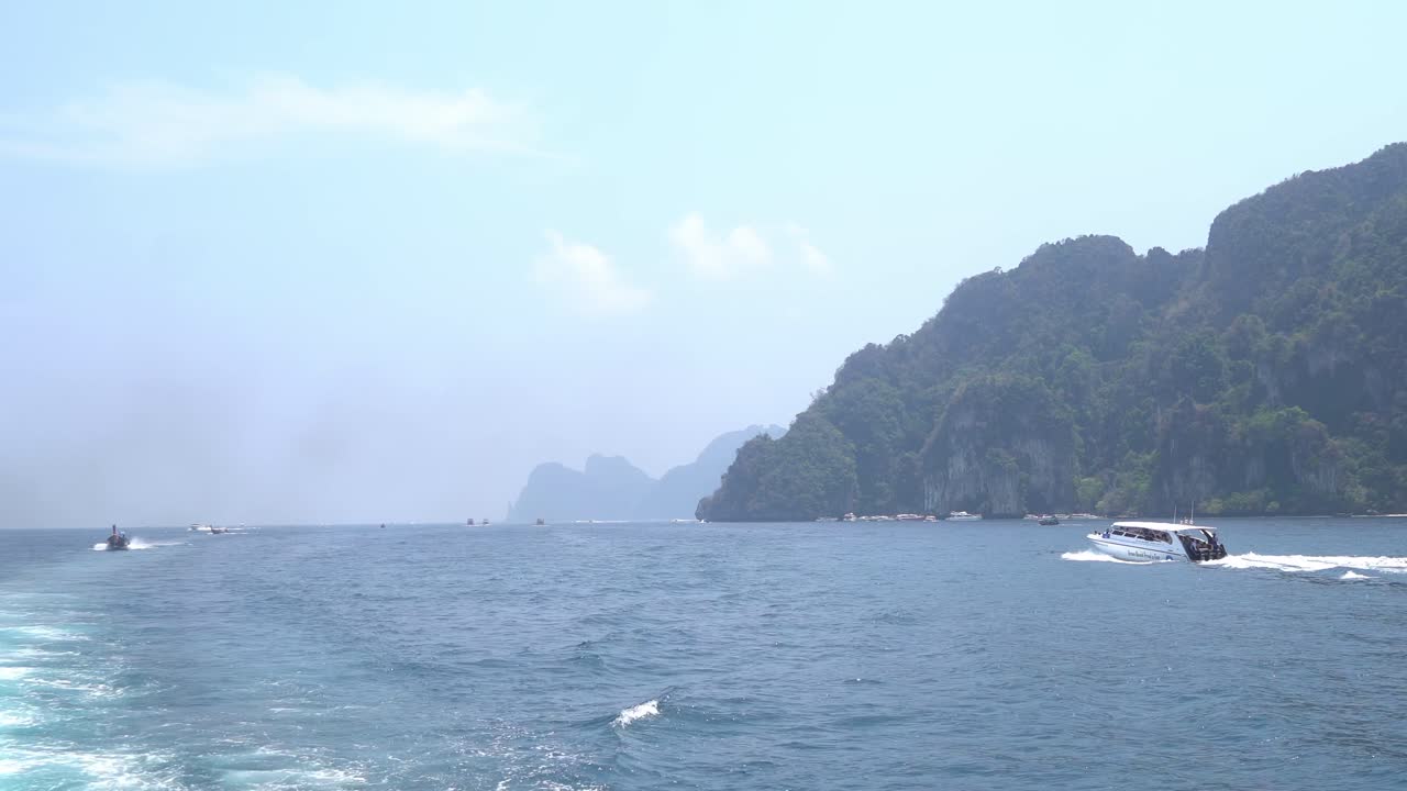 Speed boat driving tourists on to a day trip, koh phi phi, thailand
