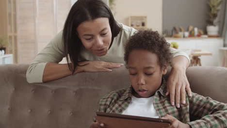 mother and son using tablet